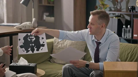 Man Discussing Inkblot Test during Therapy Session Stock Footage 340637366
