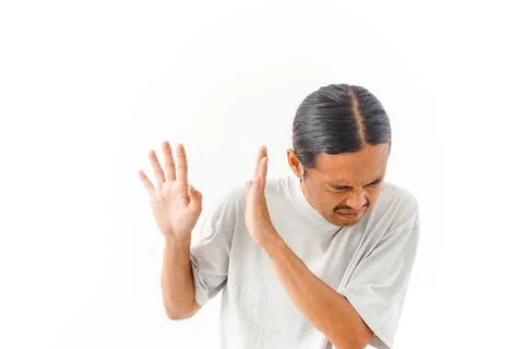 A man with a disgusted expression raises his hands in a stop gesture, wardi.. Stock Photos