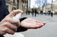 Man Disinfecting His Hands With Hand Sanitizer Stock Photos