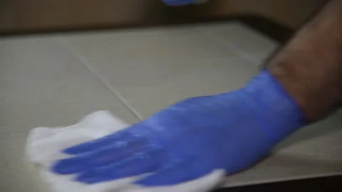 A man disinfects a table, wipes it with a rag. Stock Footage 145142437