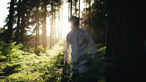 Man disinfests the forest from bacterial contamination in white suit Stock-Footage 221559451