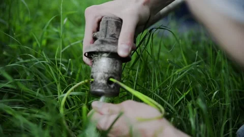 A man dismantles a lawn mower to replace spare parts Stockbeeldmateriaal 132860912