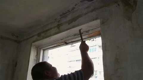 The man is dismantling the old window with his hands. Stock Footage 87644955