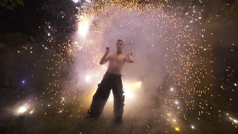 Man displaying fire patterns spinning fire poi at night Stock Footage 72507269