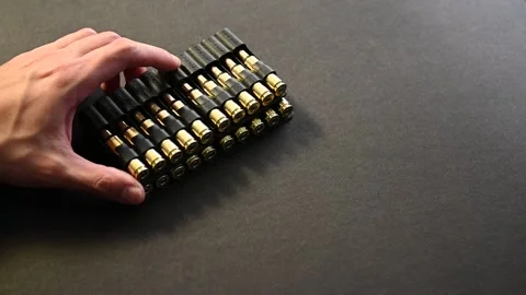 A man displaying a set of 6.5 Creedmoor ammunition Stock Footage 146287804