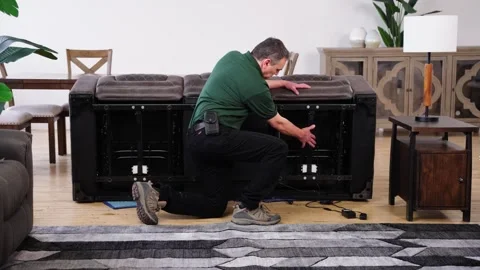 Man Displays Underside Parts of Tilted Sofa and Reclining Mechanism Video stock 307891252