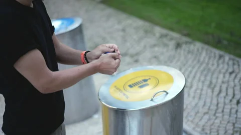 Man disposes single plastic bottle in separated garbage bin. City waste sorting. Video stock 165262640
