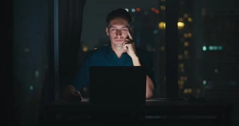 Man dissecting complex datasets under soft office lamp, analyst unlocking hidden Stock Footage 312124522