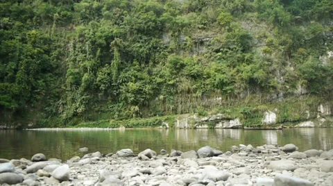 A man in the distance rows gently across a tranquil lake. Stock Footage 32720246