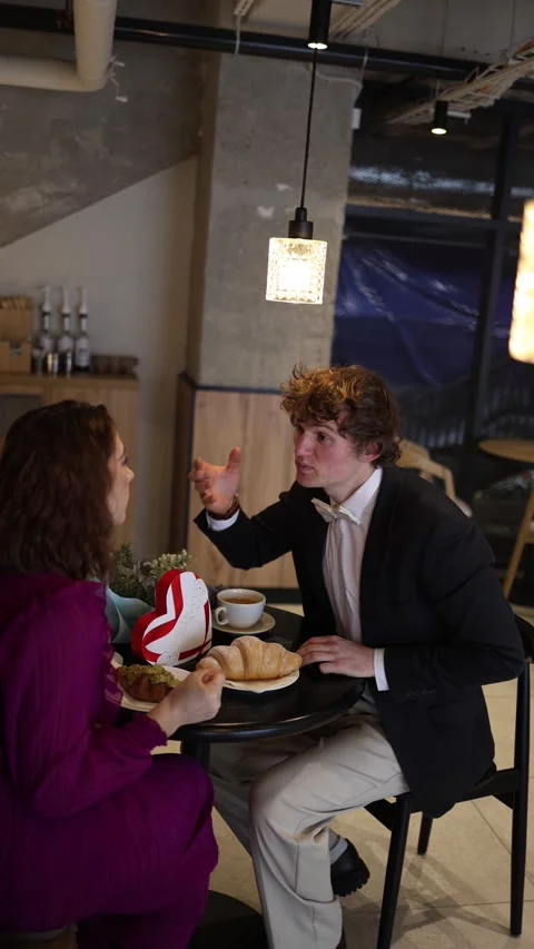 Man distracted by phone on date Stock Footage 328301398
