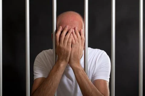 Man distressed in jail Stock Photos