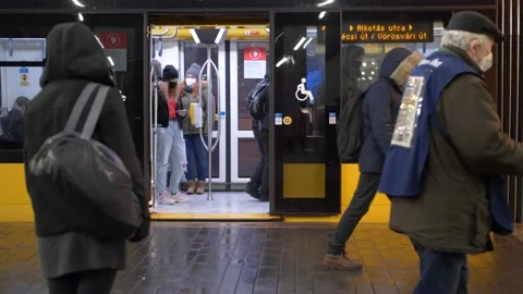 Man distributes free newspaper in front of a tram, Budapest sad socio shot Vídeo Stock 201416951