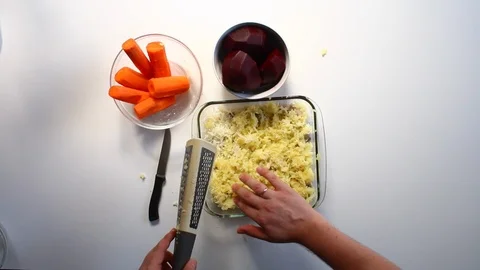 The man distributes the ground boiled potatoes in a uniform layer over the herri Vídeo Stock 87646873