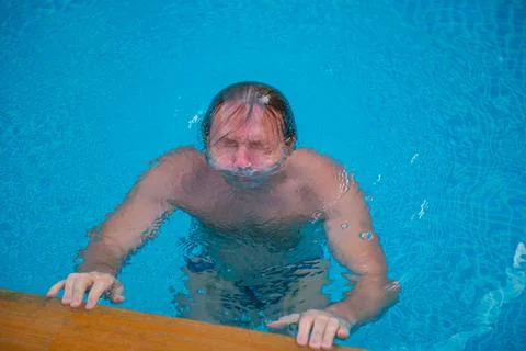 A man dived in a deep pool Stock Photos