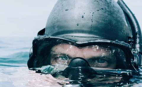 Man diver looking out over the sea. Stock Photos