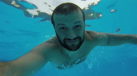 A man dives and swims under water Stock Footage 68924397