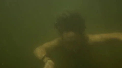 Man dives at the bottom of the river Stock Footage 143776763
