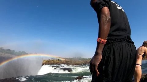 A man dives into Devil's Pool, the edge of Victoria Falls, Zambia close to the Stock Footage 113200685