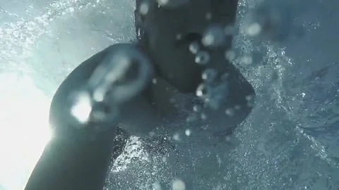 A man dives into the pool and lets bubbles Stock-Footage 163480215