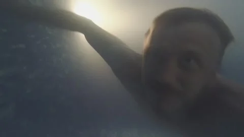 A man dives into the pool and lets bubbles Stock Footage 163480217