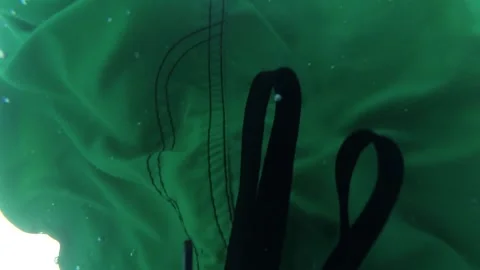 A man dives into the pool and lets bubbles Stock Footage 163480254