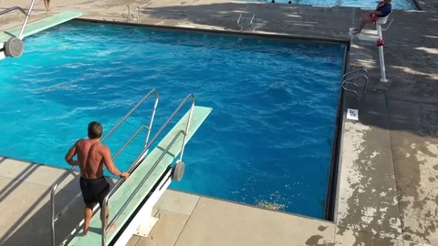 Man Dives Into Pool with Front Flip 스톡 동영상 76580380