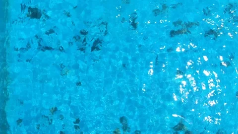 Man dives into the pool in a man dives into the pool in a villa view from a Stock Footage 119369625