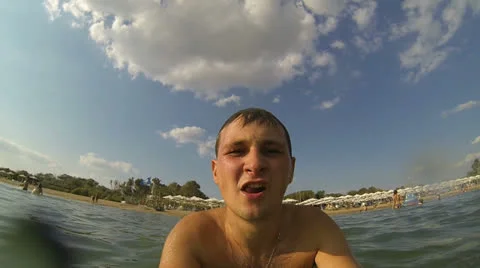 Man dives into the sea holding the camera Stock Footage 26750253