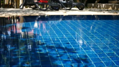 A man dives upside down in a blue pool. HD, 1920x1080, slow motion Stock Footage 96121702