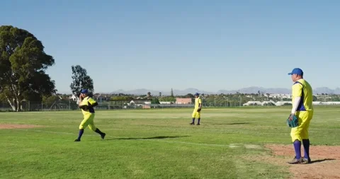 Man diving after fly ball in uniform in outfield, intercepting and tossing to Stock Footage 339160930