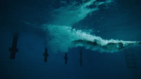 Man diving and swimming in the pool Stock Footage 283138427