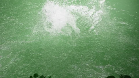 Man Diving Headfirst into Emerald Green Water in Slow Motion. Stock Footage 338384108