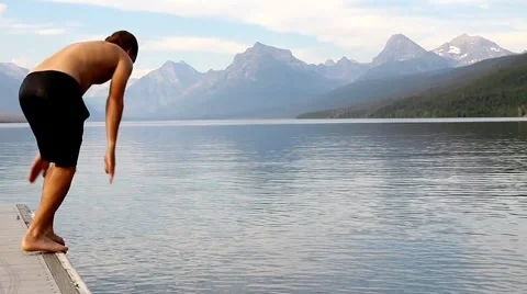Man diving into lake 2 Stock Footage 1058998