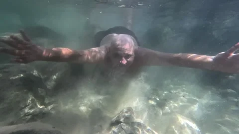 Man diving into a natural pool at Fuentes del Algar Stock Footage 327279185