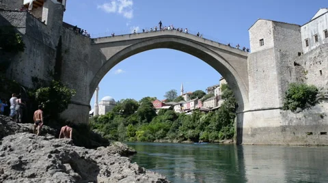 A man diving on the old brigde in Mostar, Bosnia , Bosnia and Herzegovina Stock Footage 63978219
