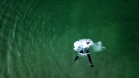 Man diving in plastics having a hard time and choking 스톡 동영상 107317044