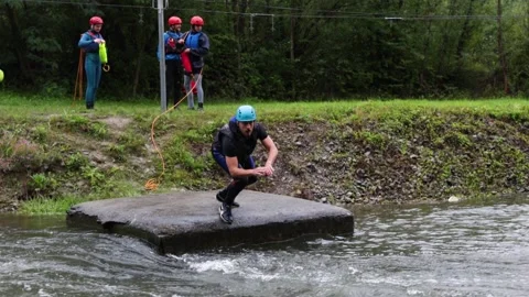 Man diving into river water in slow motion wearing helmet and life jacket Stock Footage 169622871
