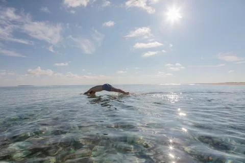 Man diving in sunny, idyllic ocean, Maldives Stock Photos