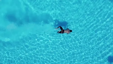 Man diving into swimming pool Video stock 156210264