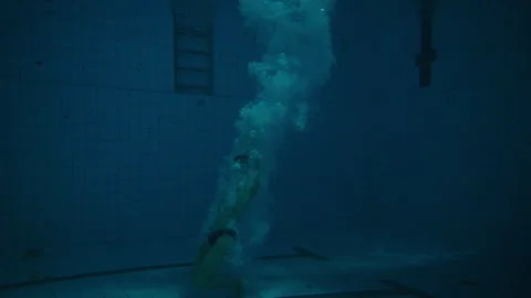 Man Diving into the swimming Pool Stock Footage 283137257