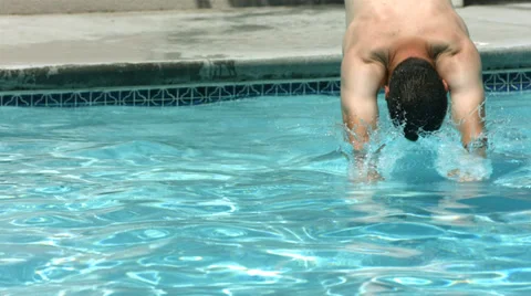 Man diving into swimming pool, slow motion Stock Footage