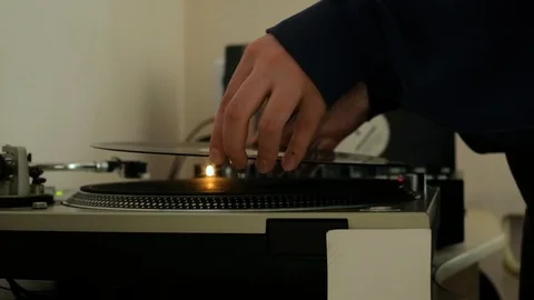 Man dj puts a vinyl record in the player (cool colors) Stock Footage 106024683