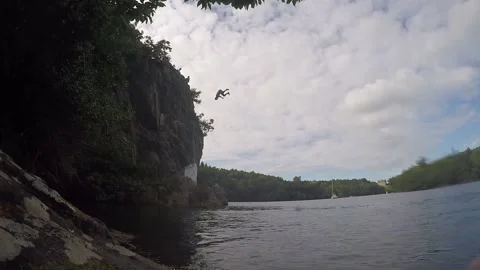 Man do a back flip in the water from 10m high, cliff jumping Stock Footage 237761662