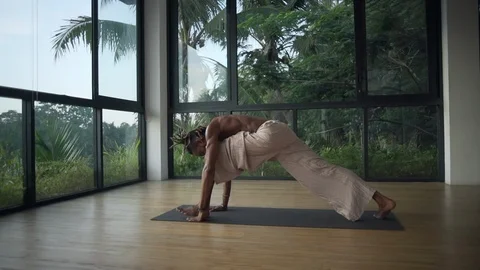 Man do downward facing dog to upward dog yoga pose in studio rapid slow motion Stock Footage 89719414