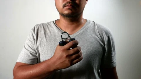 Man do exercises with squeezes hand grip. Stock Footage 78199236