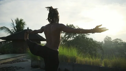 Man do extended hand to big toe yoga at roof top solar battery rapid slow motion Video stock 89726557