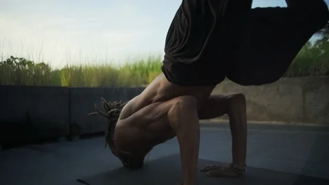 Man do forearm balance stand yoga pose roof with solar battery rapid slow motion Stock Footage 89722701