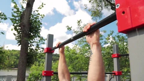 Man do pull-up on the horizontal bar, upper body 스톡 동영상 140137613
