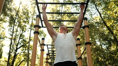 Man do pull ups in park. Stock Footage 95648421