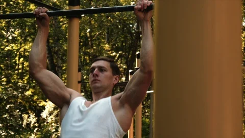 Man do pull ups at park. Stock Footage 95648434